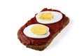 black whole grain bread with tomato paste spread on ketchup with slices of boiled egg Royalty Free Stock Photo