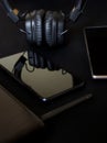 Black Wi-Fi router with an antenna on the background of mobile wireless devices: smartphone, tablet and headphones. Shades of Royalty Free Stock Photo