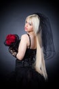 Black widow in grief with flowers with a veil Royalty Free Stock Photo