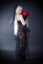 Black widow in grief with flowers with a veil Royalty Free Stock Photo