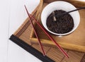 Black wild rice in a ceramic bowl with chopsticks on an oriental bamboo background Royalty Free Stock Photo