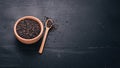 Black wild rice in a plate on a wooden background. Royalty Free Stock Photo