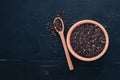 Black wild rice in a plate on a wooden background. Royalty Free Stock Photo