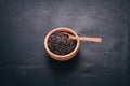 Black wild rice in a plate on a wooden background. Royalty Free Stock Photo