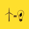 Black Wind turbine and light bulb with leaves as idea of eco-friendly source of energy icon isolated on yellow Royalty Free Stock Photo