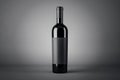 Black wine bottle with empty blank label with copyspace for your logo on abstract dark background, red wine concept. 3D rendering Royalty Free Stock Photo