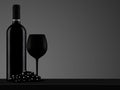 Black wine bottle with glass and grape