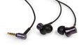 Black wired in-ear earphones close-up on white background Royalty Free Stock Photo