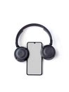 Black wireless headphone and mobile smartphone with a blank screen mockup lay on the surface of a white background Royalty Free Stock Photo