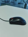 Black wireless mouse, office table Royalty Free Stock Photo