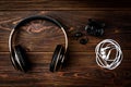 Black wireless and white wired headphones on dark wooden background Royalty Free Stock Photo