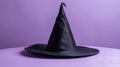 Black witch hat on a purple background