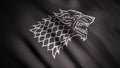 Black wolf grin silhouette on fluttering abstract flag of grey color, seamless loop. Monochrome direwolf as an emblem of