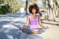 Black woman, afro hairstyle, in lotus asana with eyes closed in