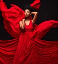 Black woman, art and fashion, red fabric on dark background with motion and aesthetic movement. Flowing silk, fantasy
