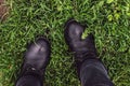 Black woman boots on green grass Royalty Free Stock Photo