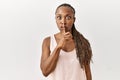 Black woman with braids standing over isolated background asking to be quiet with finger on lips Royalty Free Stock Photo