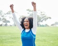 Black woman, celebration and smile for winning, success or sports victory and achievement on grass field outdoors. Happy