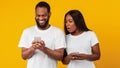 Black woman checking his boyfriend mobile phone Royalty Free Stock Photo