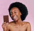 Black woman, chocolate and diet with candy and beauty, health and dessert snack on pink background. Skin, glow