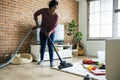 Black woman is cleaning living room