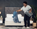 Black woman, clothes with basket and cleaning bedroom, organize mess with hygiene and hospitality. Female person