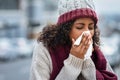 Black woman with cold sneezing outdoor Royalty Free Stock Photo