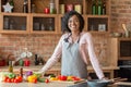 Black woman cooking healthy salad at kitchen, smiling at camera Royalty Free Stock Photo