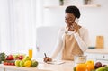 Black Woman Cooking Talking On Phone Writing Recipes In Kitchen Royalty Free Stock Photo