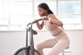 Black woman, cycling and exercise bike in gym, cardio workout and fitness challenge, training and healthy performance Royalty Free Stock Photo