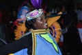 A black woman dancer in blue and green costume