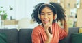 Black woman, dancing and headphones on sofa, being content and singing words in living room. Young girl, headset and Royalty Free Stock Photo