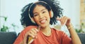 Black woman, dancing and headphones on sofa, being content and singing words in living room. Young girl, headset and Royalty Free Stock Photo