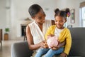 Black woman with daughter holding piggy bank Royalty Free Stock Photo