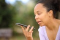 Black woman dictating message on phone