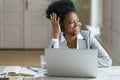 Black woman dispatcher agent wearing headset with microphone talking with customer looking at window Royalty Free Stock Photo