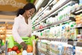 Black Woman Doing Shopping Putting Milk In Cart In Supermarket Royalty Free Stock Photo