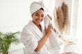 Black Woman Drying Face Doing Facial Skincare Routine In Bathroom