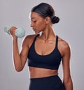 Black woman, dumbbells exercise and studio for muscle development, wellness and self care with focus. Gen z bodybuilder