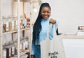 Black woman at eco friendly grocery store, recycling shopping bag and commitment to climate change at sustainable small Royalty Free Stock Photo