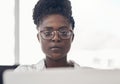 Black woman, entrepreneur and focus on computer at the office for online search for business. Professional female, tech