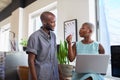 A Black woman explains something to her male colleague in trendy office Royalty Free Stock Photo