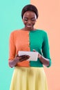 Black woman, fashion and tablet in studio, smile or happiness with color block background. Stylish, trendy or vibrant