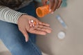 Black woman feeling sick, using pills at home