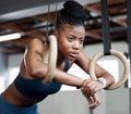Black woman, fitness and gymnastics with rings for training, muscle and arms at gym. African American female acrobat or Royalty Free Stock Photo