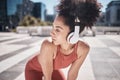 Black woman, fitness and listening to music in the city on a break from running exercise or workout. African American Royalty Free Stock Photo