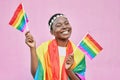 Black woman, flag and pride with lgbtq portrait, freedom and support queer community with happiness against pink