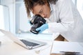 Black woman, forensic investigation and camera for laptop, it and cyber crime evidence on lab desk. Young technician Royalty Free Stock Photo