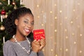 Black woman in front of christmas tree Royalty Free Stock Photo