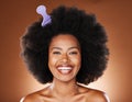 Black woman. hair care and comb in afro, happy face and skincare with smile, beauty or glow in brown studio background Royalty Free Stock Photo